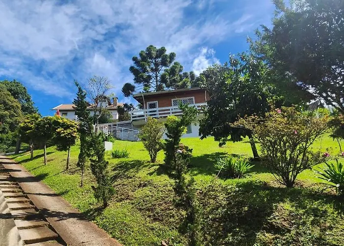 Casa com lareira,bela paisagem e deck externo com área de churrasco.